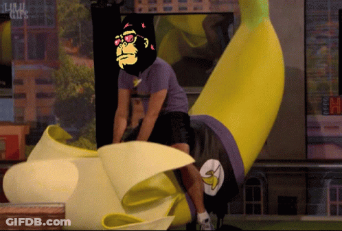 A Man In A Purple Shirt Is Riding A Banana With A Picture Of A Gorilla On His Head GIF