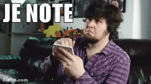 A Man In A Purple Shirt Is Sitting On A Couch Holding A Piece Of Paper With The Words Je Note On It . GIF