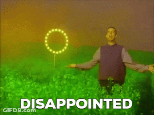 A Man In A Purple Shirt Is Standing In A Field With The Word Disappointed Written On The Bottom . GIF