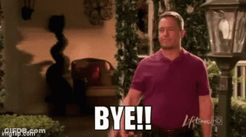 Man In Purple Shirt Saying Bye In Front Of Lamp Post GIF