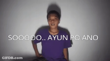 A Man In A Purple Shirt Is Standing In Front Of A Wall That Says S00000 Ayun Po Ano GIF