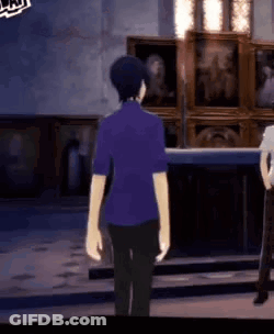 A Man In A Purple Shirt Is Standing Next To A Woman In A White Shirt In A Room . GIF