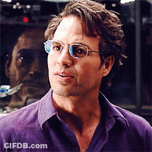 A Man In A Purple Shirt Is Wearing Glasses GIF