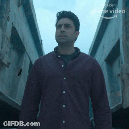 A Man In A Purple Shirt Stands In Front Of A Sign That Says Prime Video GIF
