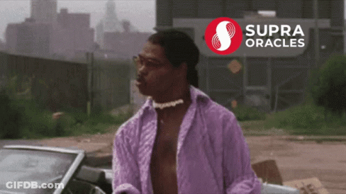 A Man In A Purple Shirt Stands In Front Of A Supra Oracles Sign GIF