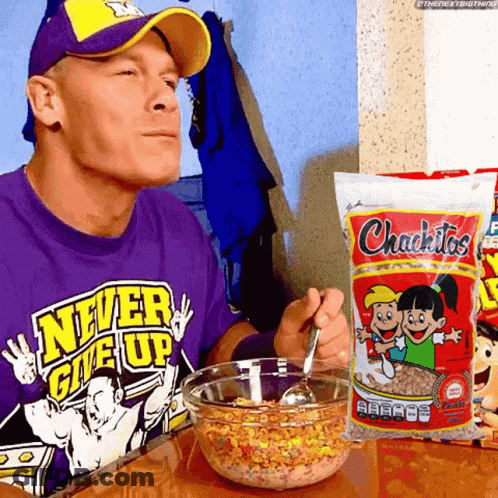 A Man In A Purple Shirt That Says Never Give Up Is Eating Cereal GIF