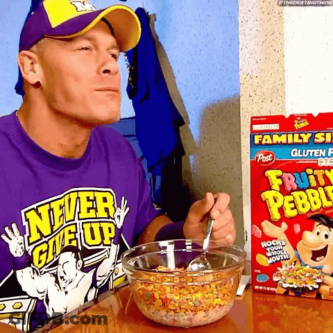 A Man In A Purple Shirt That Says Never Give Up Is Eating Fruity Pebbles GIF