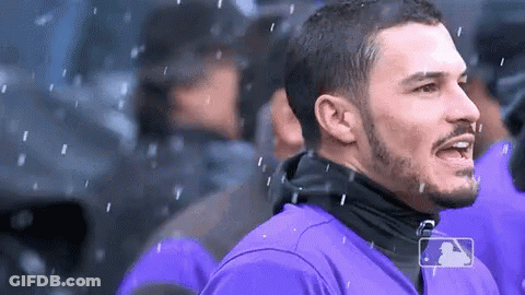 A Man In A Purple Shirt With A Mlb Logo On His Shirt GIF