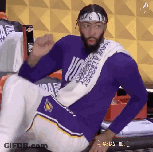 A Man In A Purple Shirt With A Towel Around His Neck That Says Save A Legend GIF