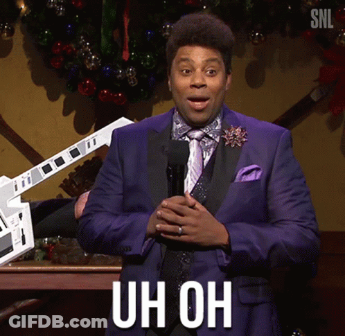 A Man In A Purple Suit And Tie Is Holding A Microphone And Says Uh Oh GIF