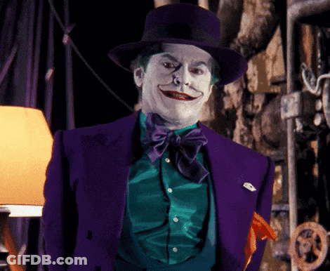 A Man In A Purple Suit And Top Hat Is Making A Funny Face GIF