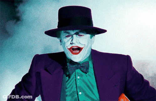 A Man In A Purple Suit And Top Hat Is Making A Funny Face GIF