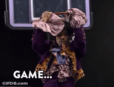 A Man In A Purple Suit Is Holding A Purse Over His Head And The Word Game Is On The Bottom Right GIF