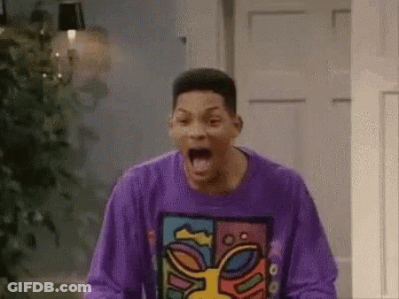 A Man In A Purple Sweater Is Screaming In A Room . GIF
