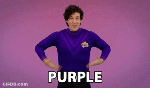 A Man In A Purple Sweater Says Purple GIF