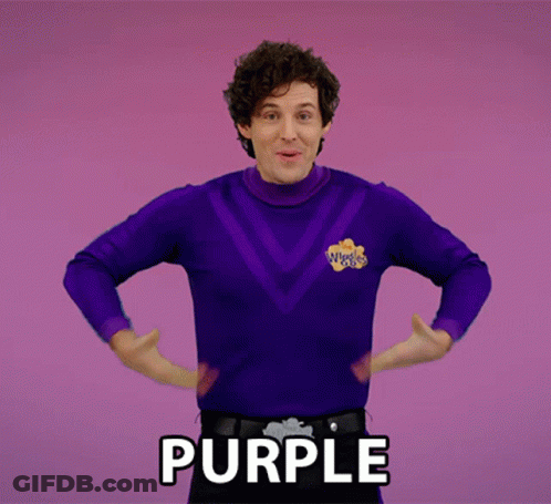 A Man In A Purple Sweater With The Word Purple Written On The Bottom GIF