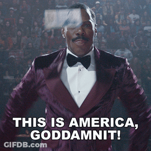A Man In A Purple Tuxedo And Bow Tie Says This Is America Goddamnit GIF