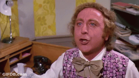 A Man In A Purple Vest And Bow Tie Is Making A Funny Face . GIF