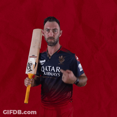 A Man In A Qatar Airways Shirt Is Holding A Cricket Bat GIF