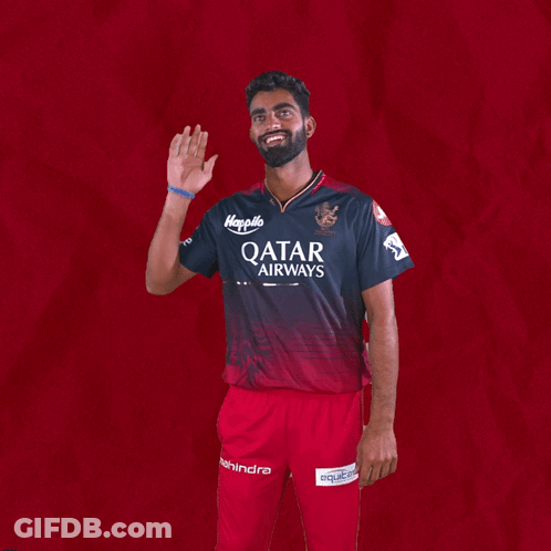 A Man In A Qatar Airways Shirt Waves His Hand GIF