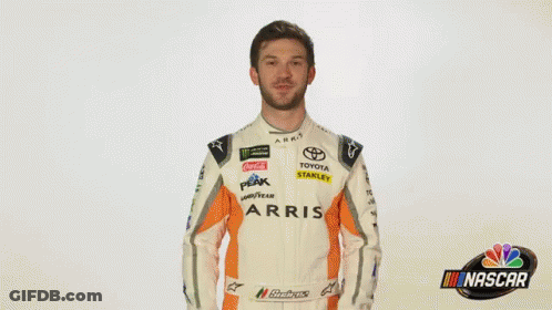 A Man In A Race Car Uniform Is Saying Wow . GIF