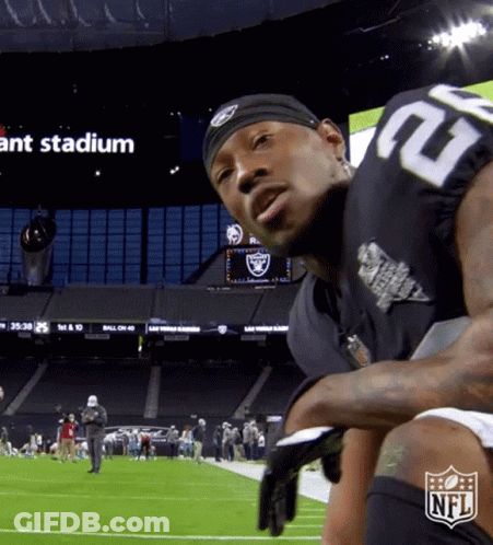 A Man In A Raiders Jersey Stands On A Football Field GIF