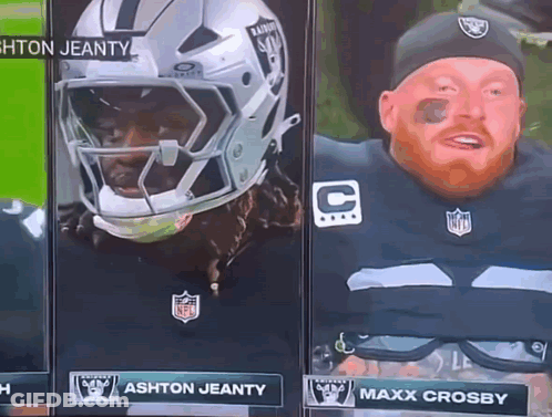 A Man In A Raiders Uniform Stands Next To A Man In A Helmet GIF