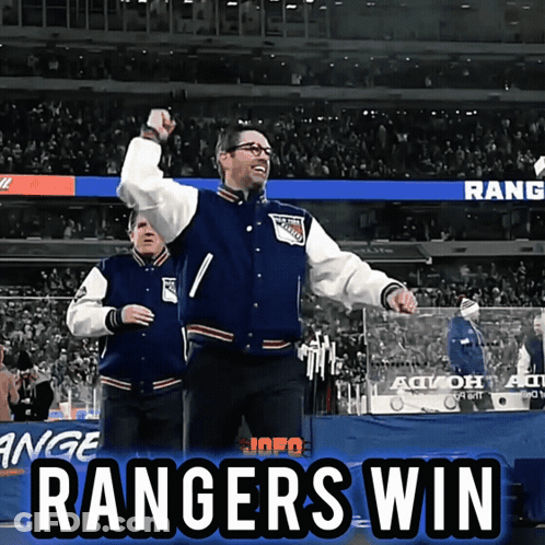 A Man In A Rangers Jacket Stands In Front Of The Crowd GIF