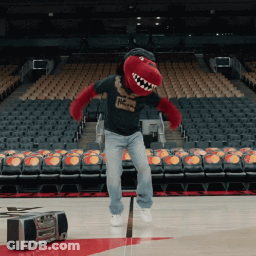A Man In A Raptors Mascot Costume Is Jumping In The Air GIF