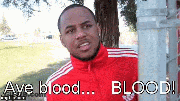 A Man In A Red Adidas Jacket Is Standing Next To A Tree GIF