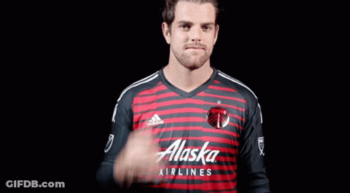 A Man In A Red And Black Alaska Airlines Shirt GIF