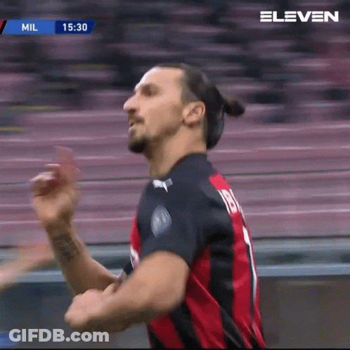 A Man In A Red And Black Jersey With The Number 18 On The Back GIF