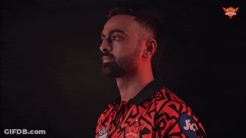A Man In A Red And Black Shirt With Jio On His Arm GIF