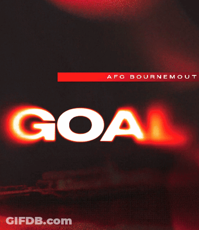 A Man In A Red And Black Striped Shirt Is Giving A Goal Sign GIF