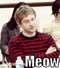 A Man In A Red And Black Striped Sweater Is Sitting With His Eyes Closed GIF