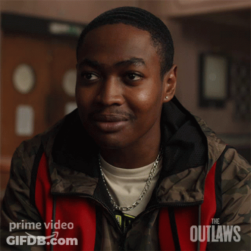 A Man In A Red And Brown Jacket With The Word Outlaws On It GIF