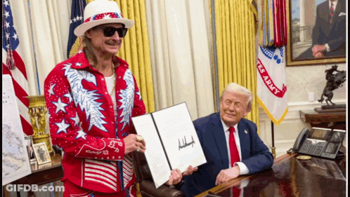 A Man In A Red And White Outfit Holds A Signed Document Next To A Man In A Suit GIF