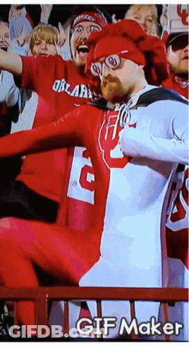 A Man In A Red And White Outfit With The Letter G On It GIF