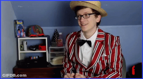 A Man In A Red And White Striped Jacket And Hat GIF