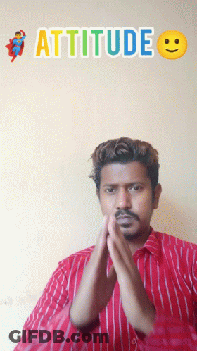 A Man In A Red And White Striped Shirt Stands In Front Of A Wall With The Word Attitude On It GIF