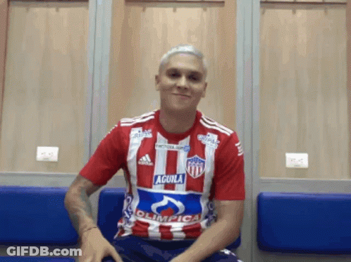 A Man In A Red And White Striped Shirt With The Word Aguila On It GIF