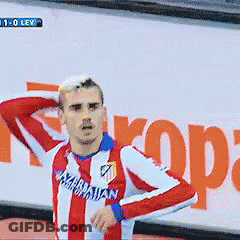 A Man In A Red And White Striped Shirt With The Word Atl On It Stands In Front Of A Sign That Says Rope GIF