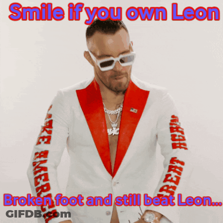 A Man In A Red And White Suit With The Caption Smile If You Own Leon GIF