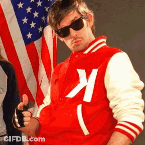 A Man In A Red And White Varsity Jacket With The Letter K On It GIF
