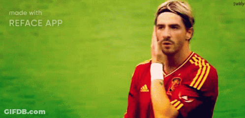 A Man In A Red And Yellow Adidas Jersey Holds His Hand To His Forehead GIF