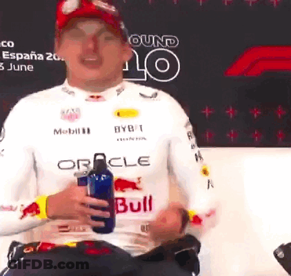 A Man In A Red Bull Shirt Is Holding A Water Bottle GIF