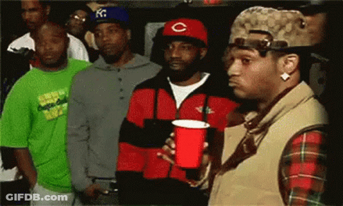 A Man In A Red C Hat Holds A Red Cup GIF