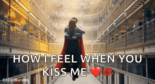 A Man In A Red Cape Is Hugging A Woman In A Hallway With The Words " How I Feel When You Kiss Me " GIF