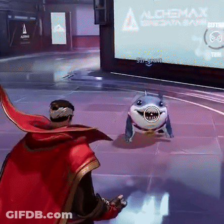 A Man In A Red Cape Is Playing A Video Game With A Shark In Front Of A Screen That Says Alchemix GIF