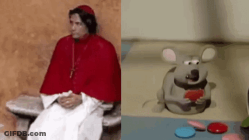 A Man In A Red Cape Is Sitting Next To A Cartoon Mouse GIF